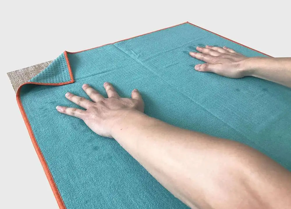 Image des mains humides sur le tapis de yoga antidérapant portable microfibre  turquoise- Les Rituels d'Isabelle